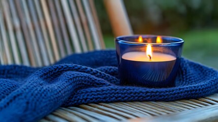 Cozy Blue Knit Blanket and Burning Candle on Wooden Chair