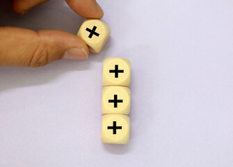 plus signs are stacked up. Added value or increasing benefits concept. Progress and profit to...