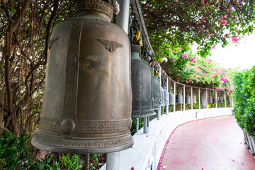 Fototapeta premium Bells hanging in a row in the golden mount temple in bangkok, thailand