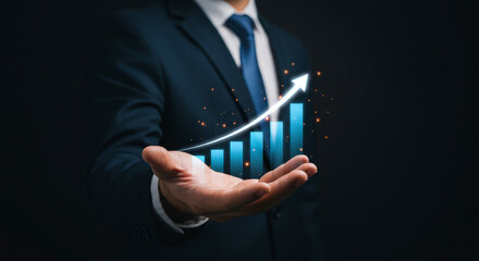 Businessman Presenting Rising Financial Growth Chart Floating Above Open Hand in Dark Background