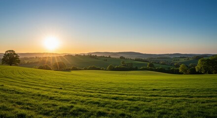 Obraz premium Lush green fields at sunset over rolling hills