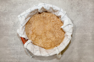 Whole wheat tortillas in a tortilla warmer.