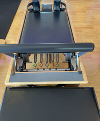 A Pilates reformer bed and sitting box.