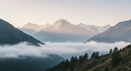 Majestic mountain range with clouds filling valleys. Light shines, creating a serene, peaceful landscape at sunrise