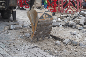Heavy machinery digs up street for construction work
