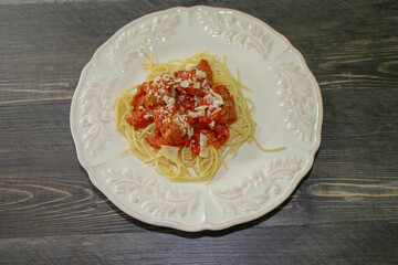 Spaghetti with meatballs topped with marinara sauce, an Italian-American dish.