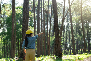 Young Girl Engineer Exploring Forest.Future Environmental Leader Pointing Towards Nature...