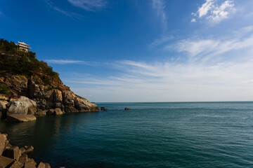 Fototapeta premium Calm blue sea and seaside rocks