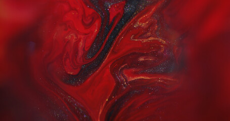 Paint drip. Ink water. Defocused red golden color splash glitter texture flowing dark black stains...
