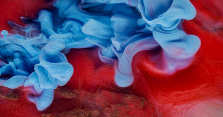 Swirling mist. Ink fluid. Defocused blue red colorful water texture smog acrylic flow floating on...