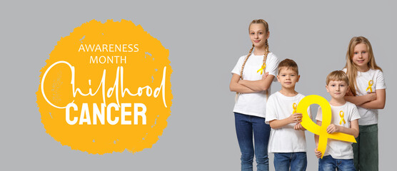 Group of kids with yellow ribbons on grey background. International Childhood Cancer Day