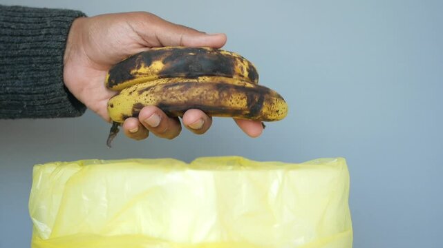 throwing away rotten bananas closeup