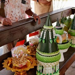 Khon Kaen, Thailand – January 2024: Traditional Khan Maak procession offerings with decorated items and snacks on golden trays during a Thai wedding.