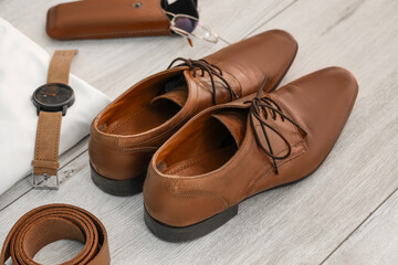 Stylish male clothes with accessories on white wooden background