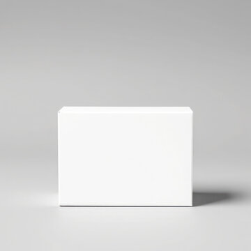 A white rectangular box sits on a light gray surface, casting a soft shadow.