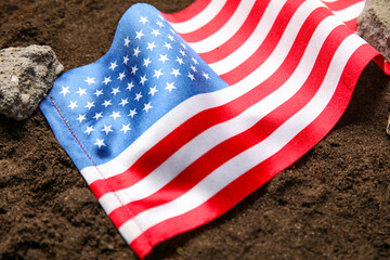 USA flag with stone debris on soil. Earthquake concept