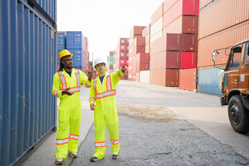 Shipyard workers are working together and checking a containers in container yard.