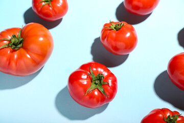 Fresh tomatoes on blue background