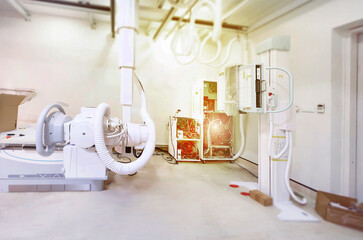 A high-tech X-ray machine in a medical room, featuring advanced equipment and intricate wiring. It’s ready to provide clear and detailed imaging for diagnostics.