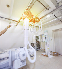 A high-tech X-ray machine in a medical room, featuring advanced equipment and intricate wiring. It’s ready to provide clear and detailed imaging for diagnostics.