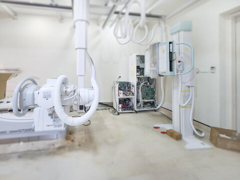 A high-tech X-ray machine in a medical room, featuring advanced equipment and intricate wiring. It’s ready to provide clear and detailed imaging for diagnostics. - Powered by Adobe