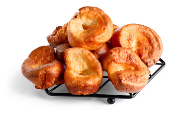 Cooling rack with tasty Yorkshire pudding isolated on white background