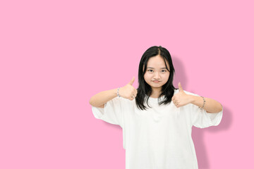 cute asian girl giving thumbs up for your victory and accomplishment