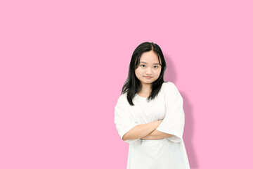Fototapeta premium Young Woman with Arms Folded, Expressing Defensiveness or Seriousness