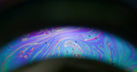Soap bubble. Neon arch. Colorful round lens paint mix light flow on black background. Purple blue...