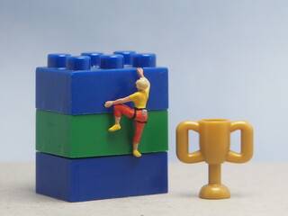 Mini toy of action figure at table with blurred background. Miniature diorama photography concept...
