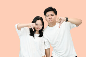 young asian man and woman showing rejection or no gesture