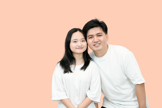 smilling asian man and woman in a photo shot studio
