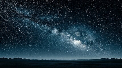 Milky way galaxy above a flat desert landscape.