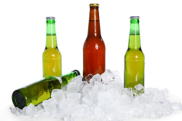 Bottles of cold beer and ice cubes on white background
