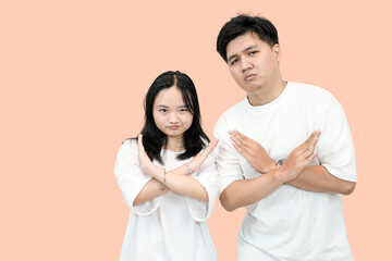 young asian man and woman showing rejection or no gesture