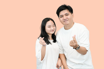 Young Asian Couple Making Finger Heart Gesture: Love and Affection