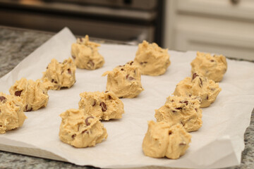 A tray of unbaked chocolate chip cookie dough balls.