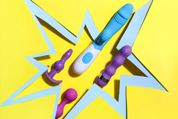 Sex toys visible through cut color paper