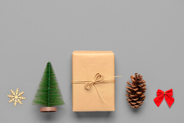 Christmas gift box with decor on grey background