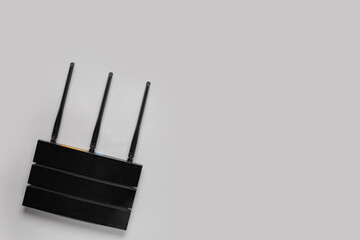 Modern wi-fi router on grey background