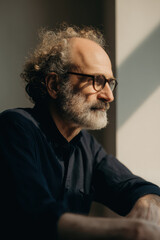 portrait of literary editor in calm studio setting positioned on right side of frame