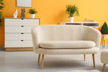 Stylish interior of living room with sofa and chest of drawers