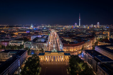 Brandenburg gate and berlin skyline illuminating at night, germany