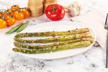 Grilled asparagus sprouts served red pepper