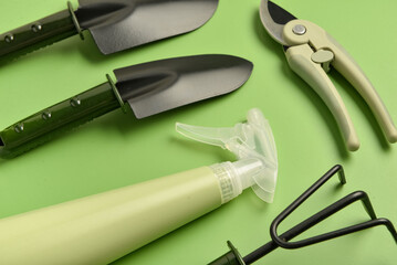 Set of gardening tools on green background