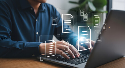 Man in blue shirt typing on laptop with holographic document icons, symbolizing digital work, data management, and modern office productivity.