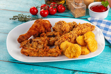 Golden crispy fried chicken mix - wings, drumsticks, nuggets and strips