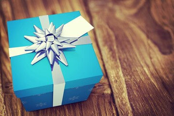 Flat design is featuring close-up blue gift box with white ribbon, silver bow, small white tag