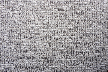 close-up shot of a tightly woven fabric with a mix of light gray and darker threads