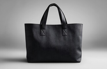 Black Tote Bag Mockup with Minimalist Design on Gray Background

